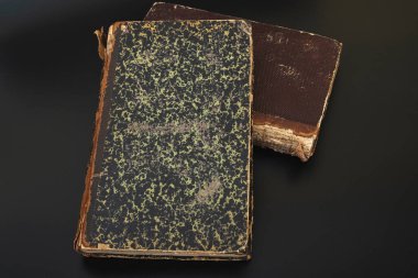 Close-up of several ancient books on a dark background.antiques.Matthew Gospel Bible 1871
