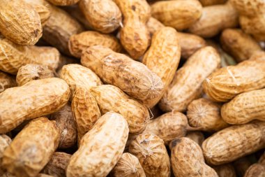 Peanuts in shell isolated on white background. Heap of peanuts close up
