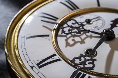 Vintage Clock with Hands. Close up view on clock face of a historical watches with golden frame