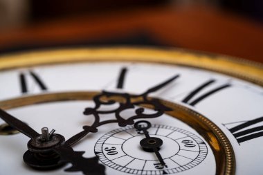 Vintage Clock with Hands. Close up view on clock face of a historical watches with golden frame