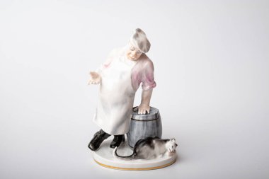 Rare porcelain figurines on a white background. Fat cook and cat eats fish