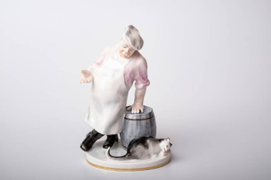 Rare porcelain figurines on a white background. Fat cook and cat eats fish