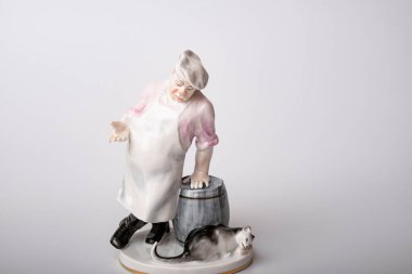 Rare porcelain figurines on a white background. Fat cook and cat eats fish