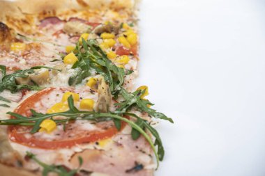 Pieces of pizza with spices on a black background, copy space, top view