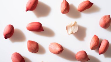 Peanuts in shell isolated on white background. Heap of peanuts close up