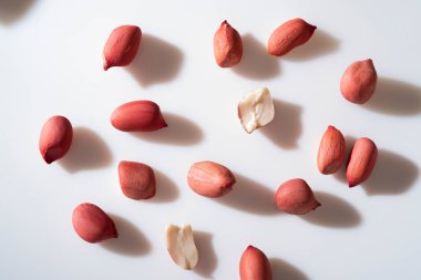 Peanuts in shell isolated on white background. Heap of peanuts close up