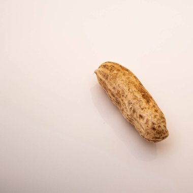 Peanuts in shell isolated on white background. Heap of peanuts close up