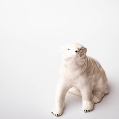 Figurine made of white stone. Polar bear on a white background.