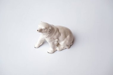 Figurine made of white stone. Polar bear on a white background.