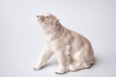 Figurine made of white stone. Polar bear on a white background.