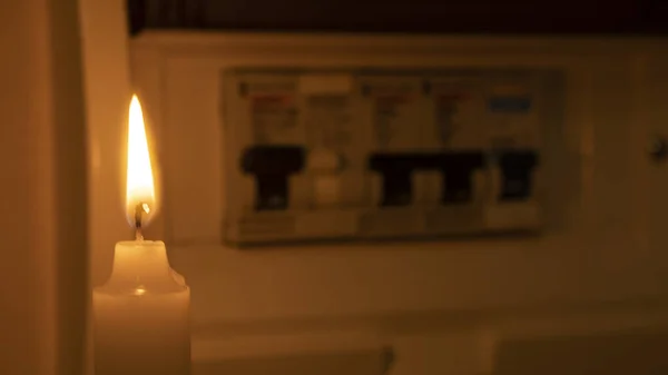 stock image candle and electrical switches, electricity cut-off, blackout