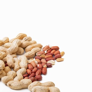 Peanuts in shell isolated on white background. Heap of peanuts close up