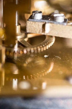 The mechanism of an old watch. clock mechanism made in the technique of toning. Focus on the central gears. Very shallow depth of field