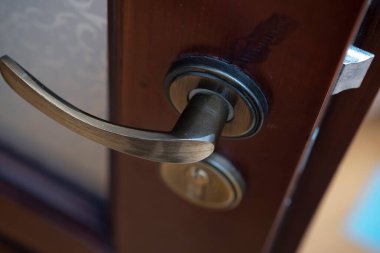a wooden door, a copper door handle or a handle on a wooden door in beautiful lighting