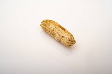 Peanuts in shell isolated on white background. Heap of peanuts close up
