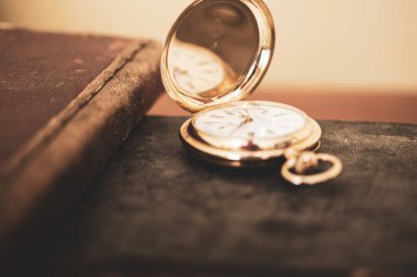 vintage gold pocket watch longines isolated on white background