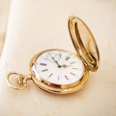 vintage gold pocket watch longines isolated on white background