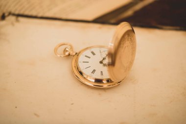 vintage gold pocket watch longines isolated on white background