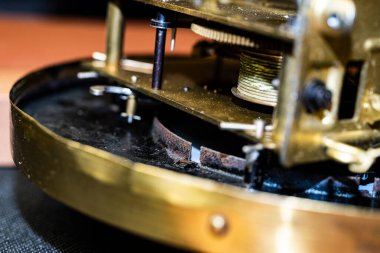 Eski bir saat mekanizması. Tonlama tekniğinde yapılmış bir saat mekanizması. Merkezi dişlilere odaklan. Çok sığ bir alan..