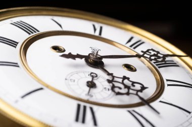 Elleri olan antika bir saat. Altın çerçeveli tarihi bir saatin saat yüzüne yakından bak.