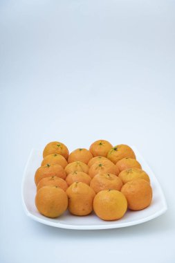 tangerine on a white background. How to choose, store and how much you can eat so as not to harm the body.
