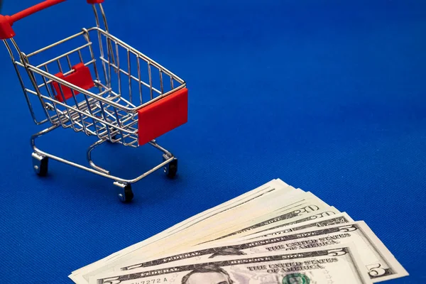 Grocery Cart Blue Background Currency — Stock Photo, Image