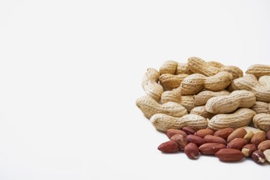 Peanuts in shell isolated on white background. Heap of peanuts close up