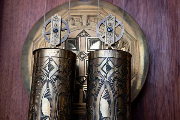 stock image Old wooden clock with a pendulum hanging on the wall