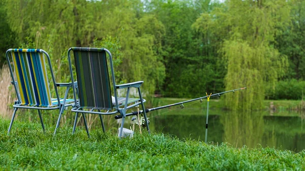 Chair and fishing rods Stock Photos, Royalty Free Chair and