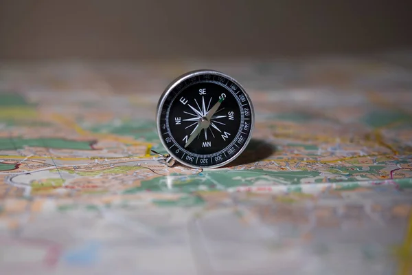 compass on the background of the map. travel concept. route planning. find your direction in life