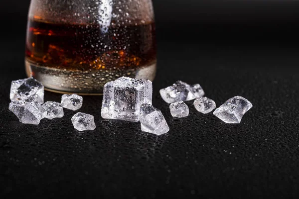 stock image whiskey with ice on a wooden table. Reasonable consumption of alcoholic beverages