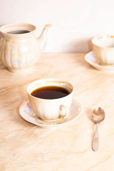 stock image Top view of herbal tea in a cup and teapot on marble. English breakfast