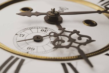 Elleri olan antika bir saat. Altın çerçeveli tarihi bir saatin saat yüzüne yakından bak.