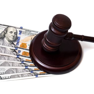 Judge's gavel and 100 american dollar banknotes on white background