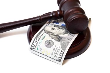 Judge's gavel and 100 american dollar banknotes on white background