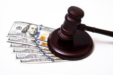 Judge's gavel and 100 american dollar banknotes on white background