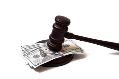 Judge's gavel and 100 american dollar banknotes on white background