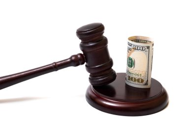 Judge's gavel and 100 american dollar banknotes on white background
