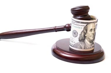 Judge's gavel and 100 american dollar banknotes on white background