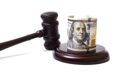 Judge's gavel and 100 american dollar banknotes on white background