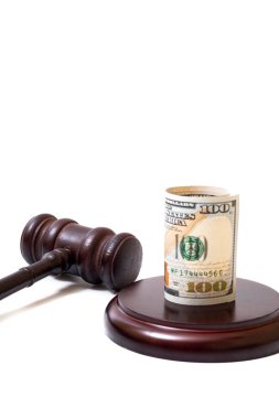 Judge's gavel and 100 american dollar banknotes on white background