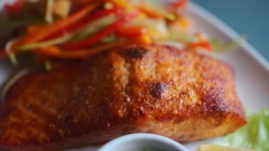 tasty delicious grill red salmon fish with veggie salad, close-up