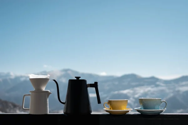 delicious filtered black coffee on mountain background, two mug