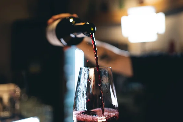 stock image barman hand pour old wine In glass