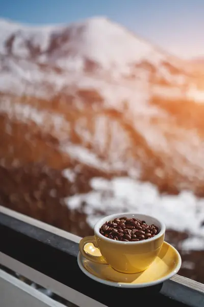 mug with black coffee grain on in mountains