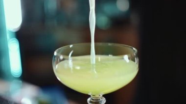 Barmen yeşil alkol kokteylini salatalık, limon, kivi ve tarhun ile hazırla. Yüksek kaliteli FullHD görüntüler
