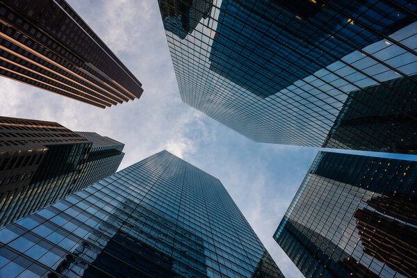 Tall skyscrapers buildings looking up perspective, modern architecture of steel and glass, skyline of big city. High quality photo