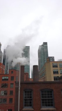 New York ya da Toronto 'da buharlı baca borusu, şehirli gökdelenler üzerine duman yığını. Yüksek kalite 4k görüntü