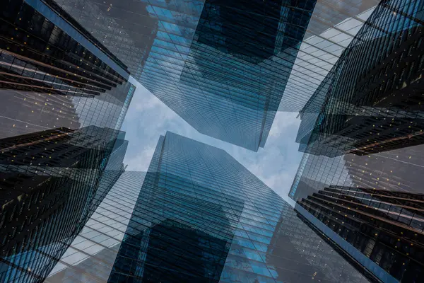 symmetry and mirrored geometry pattern, reflected skyscrapers and modern buildings abstract background, lines and tunnel futuristic technology concept. High quality photo