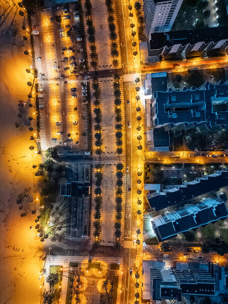 Illuminated streets of Spanish touristic city Salou, Catalonia, aerial view of beach. High quality photo